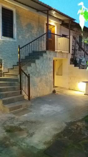 a set of stairs leading to a building with a door at MARIANTHI'S STONE HOUSE- Studio2 in Metangítsion