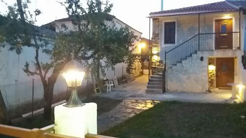 a lamp in the yard of a house at night at MARIANTHI'S STONE HOUSE- Studio2 in Metangítsion