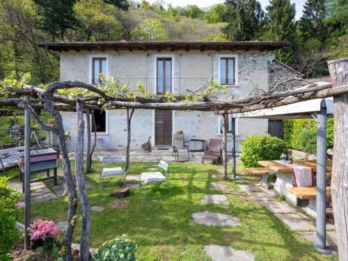 a house with a garden with a tree at Holiday Home Meri by Interhome in Cannero Riviera