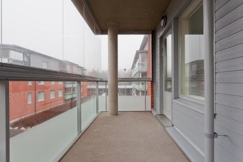 an empty hallway of a building with a window at Forenom Serviced Apartments Turku Laukkavuori in Turku