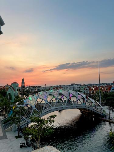 a bridge over a river in a city at Legacy Hotel - Grand World Phú Quốc in Phu Quoc