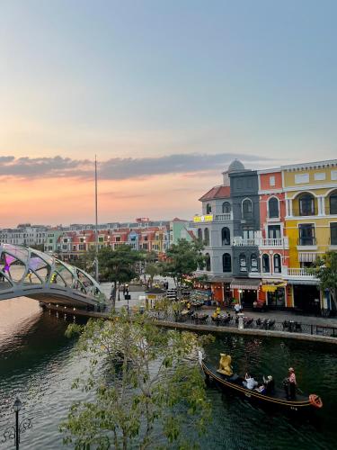 a group of people in a gondola on a river at Legacy Hotel - Grand World Phú Quốc in Phu Quoc