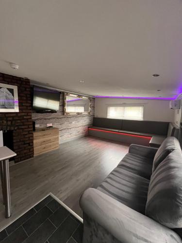 a large living room with a couch and a table at 19 Rodney Street Apartments in Liverpool