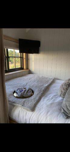 a bed with a towel on top of it at The Winford Retreat in Winford