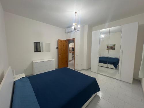 a bedroom with a blue bed in a room at Villa Maccioni in Budoni