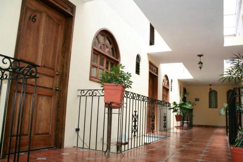 a hallway with a door and a potted plant at Hotel Posada Santa Fe in Ocotlán