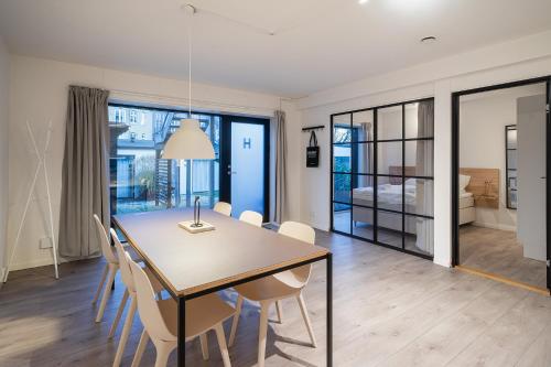 a dining room with a table and chairs at Fantastic apartment wprivate terrace in Aarhus