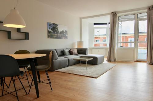 a living room with a couch and a table at Fantastic 2-bed in Frederiksberg C in Copenhagen