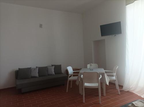a living room with a couch and a table and chairs at Dimora Erminia in Polignano a Mare