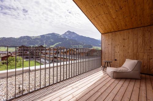 a room with a balcony with a view of mountains at Kitzbühel Suites by ALPS RESORTS in Oberndorf in Tirol