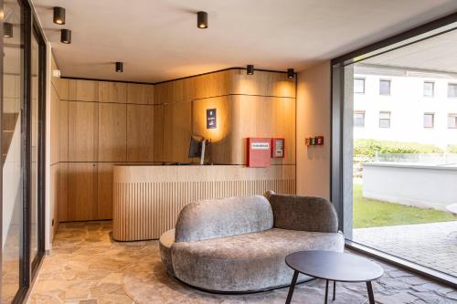 a living room with a couch and a table at Kitzbühel Suites by ALPS RESORTS in Oberndorf in Tirol