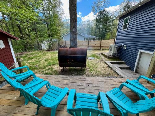 a group of chairs and a grill on a deck at Bear Run Bungalow in Hawley
