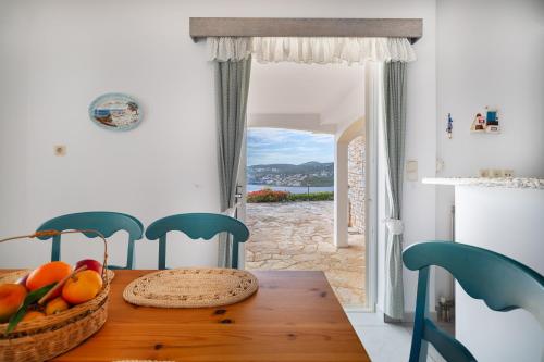 a dining room table with a basket of fruit on it at Villa Asossa with Private pool & Sea view in Dhaskalión