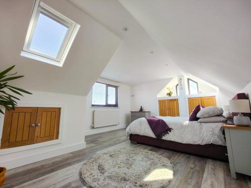 a bedroom with a bed and a rug at Surfers Lodge - Rest Bay, Porthcawl in Porthcawl
