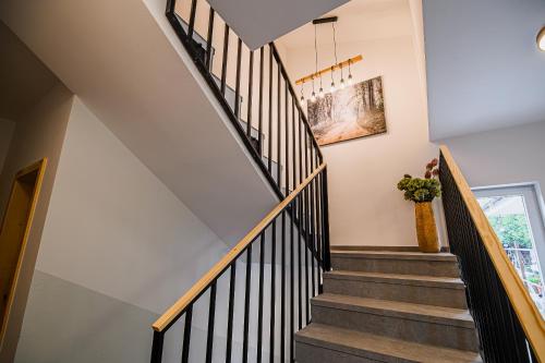 a staircase with black and white railings in a house at B&B Mio Nonno Rooms Ljubljana Ex Bizeljčan Rooms in Ljubljana