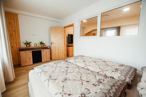 a bedroom with a bed and a large window at B&B Mio Nonno Rooms Ljubljana Ex Bizeljčan Rooms in Ljubljana