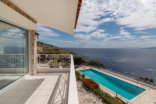 a view of the ocean from the balcony of a house at Villa Asossa with Private pool & Sea view in Dhaskalión