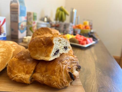 a group of croissants sitting on a wooden table at Morven Guest House Carnoustie in Carnoustie