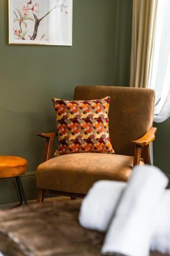 a living room with a couch and a pillow at Hob Hurst in Buxton