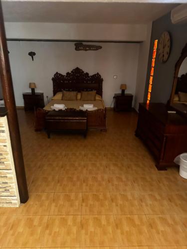 a bedroom with a bed and a wooden floor at Pansion Angela in Skiathos Town