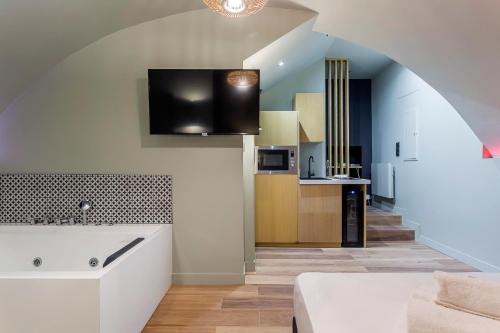 a kitchen with a sink and a living room at Suite Romantique Balnéo Centre Lyon in Lyon