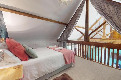 a bedroom with a bed in a attic at West Hollowcombe Farm Cottages - full site in Dulverton