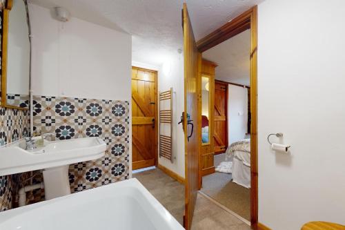 a bathroom with a sink and a mirror at West Hollowcombe Farm Cottages - full site in Dulverton