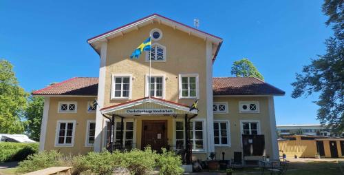 a building with a flag on the front of it at Charlottsborgs Camping och Vandrarhem in Kristianstad
