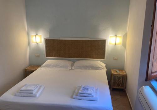 a bedroom with a bed with two towels on it at Casa Per 4 in Porto Santo Stefano