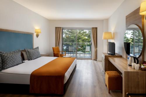 a hotel room with a bed and a television at Marvida Family Eco - Ultra All Inclusive & Kids Concept in Side