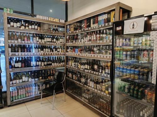 a store filled with lots of bottles of alcohol at Skynest Residences by Lisa's Paradise E in Nairobi