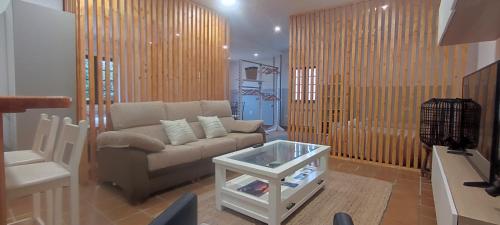 a living room with a couch and a table at Casa con finca cerca de playas in Valdoviño