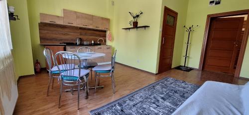 a kitchen with a table and chairs in a room at Hotel Grodzki in Sandomierz
