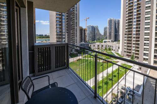 a balcony with chairs and a view of a city at Belgrade Waterfront Residences - Beograd na vodi in Belgrade