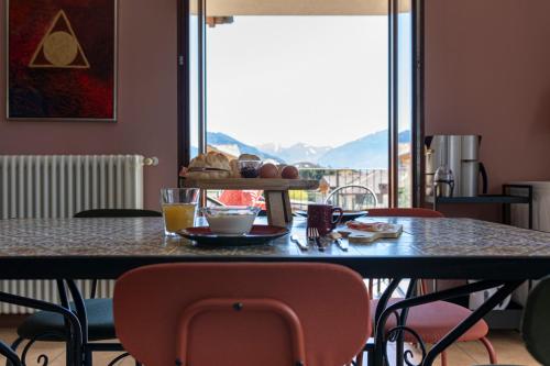 a table with chairs and a table with food on it at Casa Vista Lago in Sorico