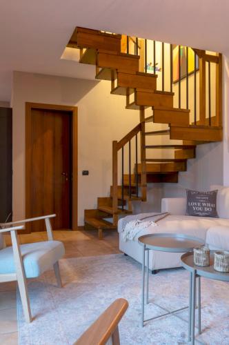 a living room with a couch and a staircase at Casa Vista Lago in Sorico
