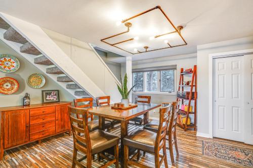 a dining room with a table and chairs and a staircase at Boat Slip and Pools Waterfront Osage Beach Condo! in Osage Beach