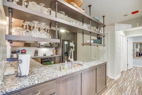 a kitchen with a counter with glasses on the shelves at Boat Slip and Pools Waterfront Osage Beach Condo! in Osage Beach