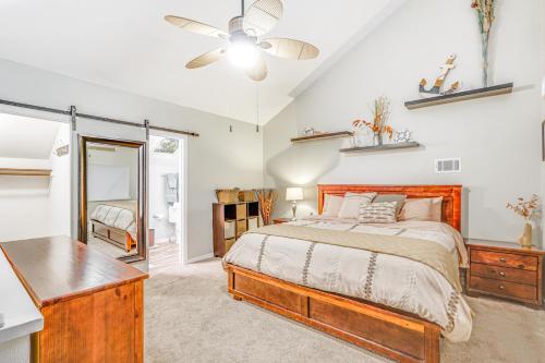 a bedroom with a bed and a ceiling fan at Boat Slip and Pools Waterfront Osage Beach Condo! in Osage Beach