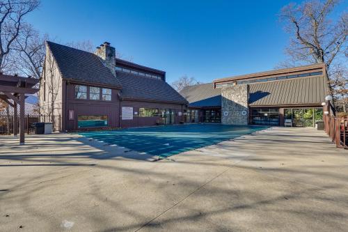 a large building with a driveway in front of it at Boat Slip and Pools Waterfront Osage Beach Condo! in Osage Beach