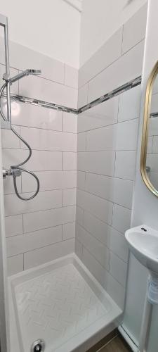 a white bathroom with a shower and a sink at SeaYouSoon Inn Cannes - Studios in Cannes