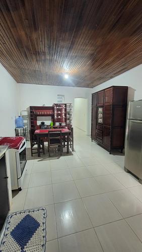 a kitchen with a table and chairs in a room at Casa no centro de Areia in Areia