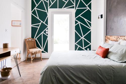 - une chambre dotée d'un lit avec un mur vert dans l'établissement Superbe maison de vacances entre plage et marais - 7 pers, à Brem-sur-Mer