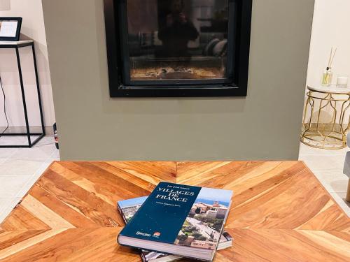 a book sitting on top of a coffee table at Gîte de L'Oliviade - Campagne & Confort in Billancelles