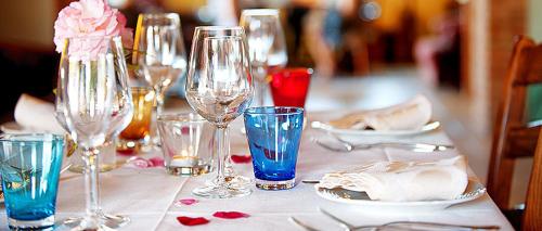 a table with wine glasses and plates on it at Agriturismo Gattogiallo in Montegabbione