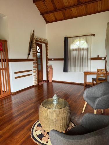 a living room with a table and chairs at Hotel Ambalakely in Ambalakely