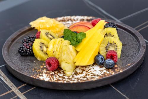 a plate of fruit on top of a table at Coastlands Skye Hotel, Ridgeside, Umhlanga in Durban
