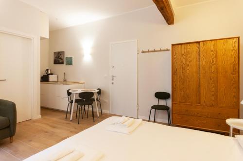 a room with a bed and a table and chairs at Youhosty - Ticinese Suite 2 in Milan