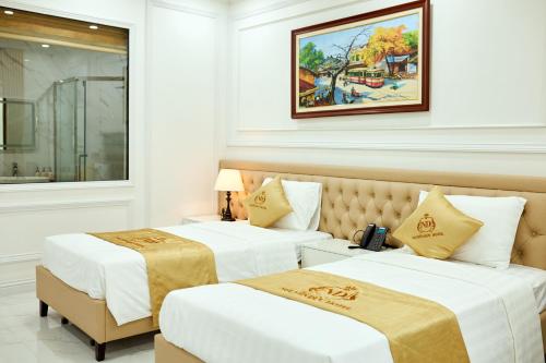 two beds in a hotel room with at Nguyễn Đức DC Hotel & Spa in Hai Phong