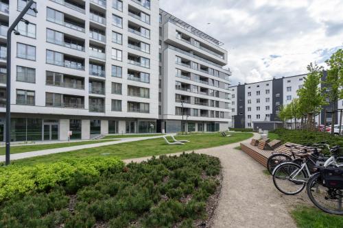 a building with bikes parked in front of a park at 04 Gdynia Premium - Apartament Mieszkanie dla 4 osób in Gdynia